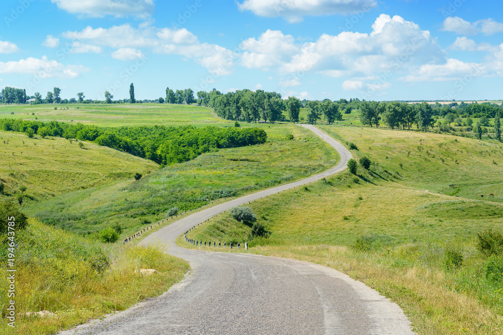 Winding road among fields in countryside. Winding road among fields in countryside.