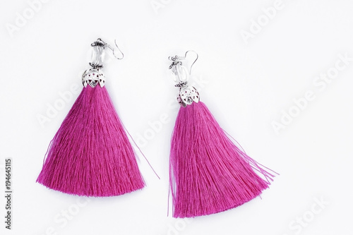Pink handmade earrings on a white background.
