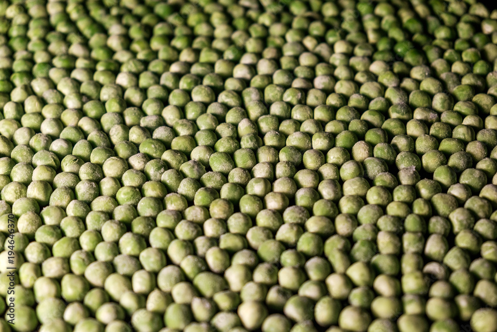 green deep frozen garden peas - above, close up, dark tones green deep frozen garden peas - above, close up, dark tones