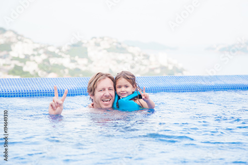 Swimming lesson, father and daughter