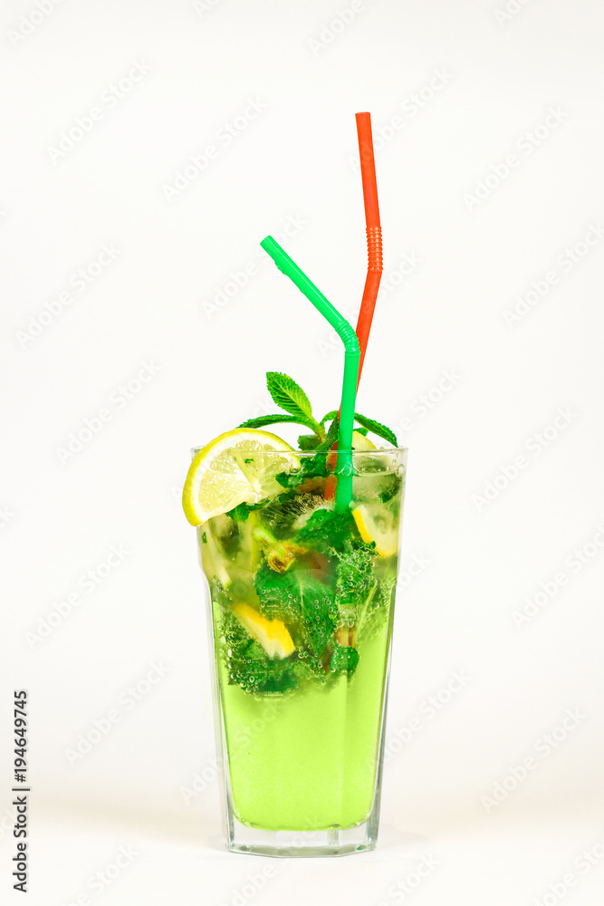 mojito with ice in a glass and colored tubules