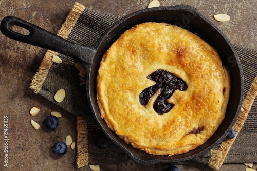 Pi Day special homemade blueberry pie baked in a skillet overhead view photo