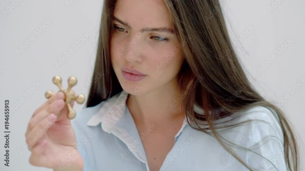 Schooler girl is rotating spinner for concentrating. Woman is looking on it and relaxing, camera is closing to spinner and focusing Schooler girl is rotating spinner for concentrating. Woman is looking on it and relaxing, camera is closing to spinner and focusing
