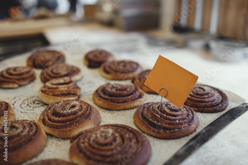 Close-up of fresh baked food with label on table at bakery