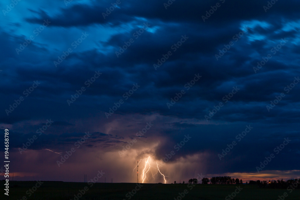 Huge lightning bolt lights up the sky at sunset