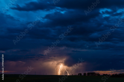 Huge lightning bolt lights up the sky at sunset