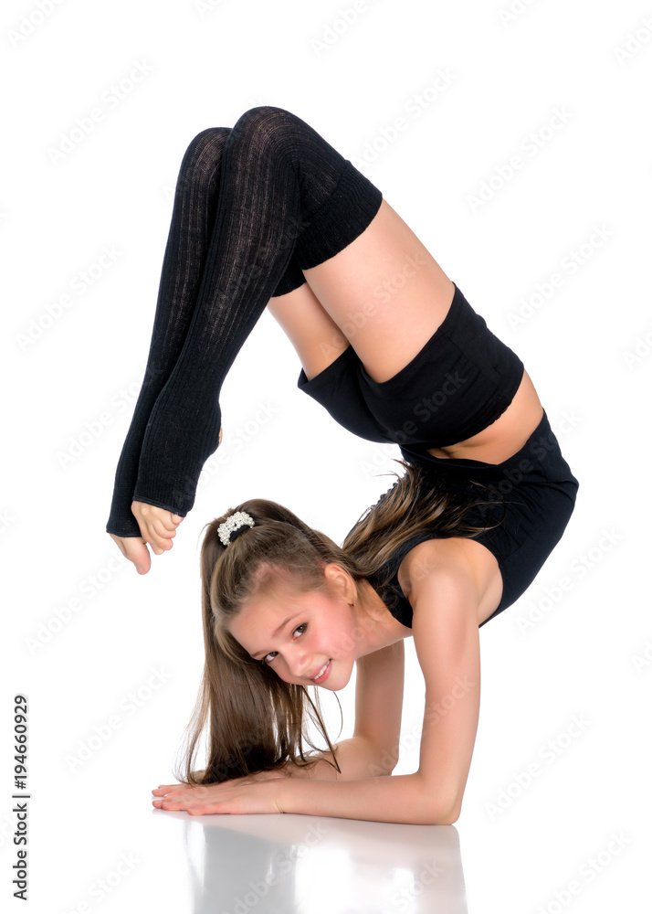 The gymnast perform an acrobatic element on the floor. The gymnast perform an acrobatic element on the floor.