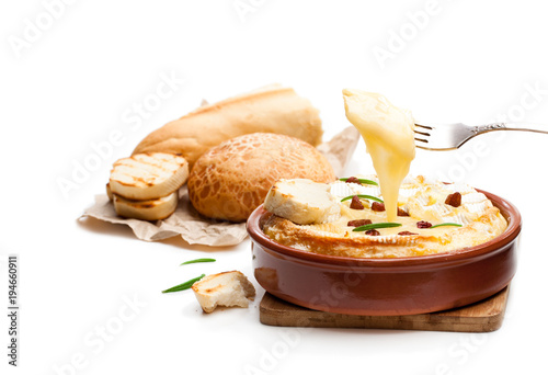 Delicious  hot baked camembert with sultanas isolated on white
