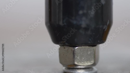 Putting a pop rivet with manual pop gun macro shot photo