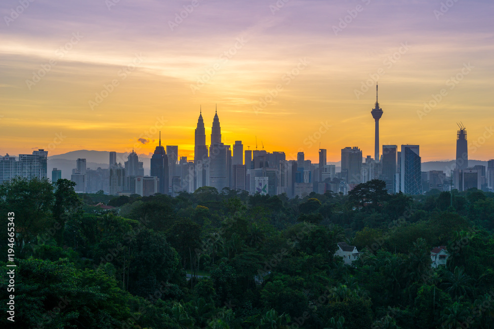 Majestic sunrise over Petronas Twin Towers and surrounded buildings in downtown Kuala Lumpur, Malaysia