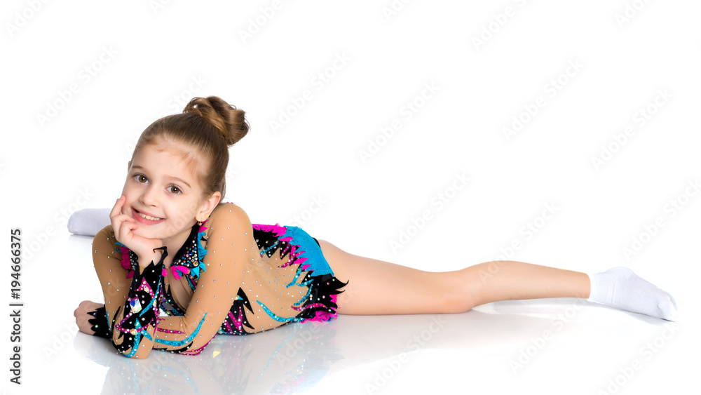 The gymnast perform an acrobatic element on the floor. The gymnast perform an acrobatic element on the floor.