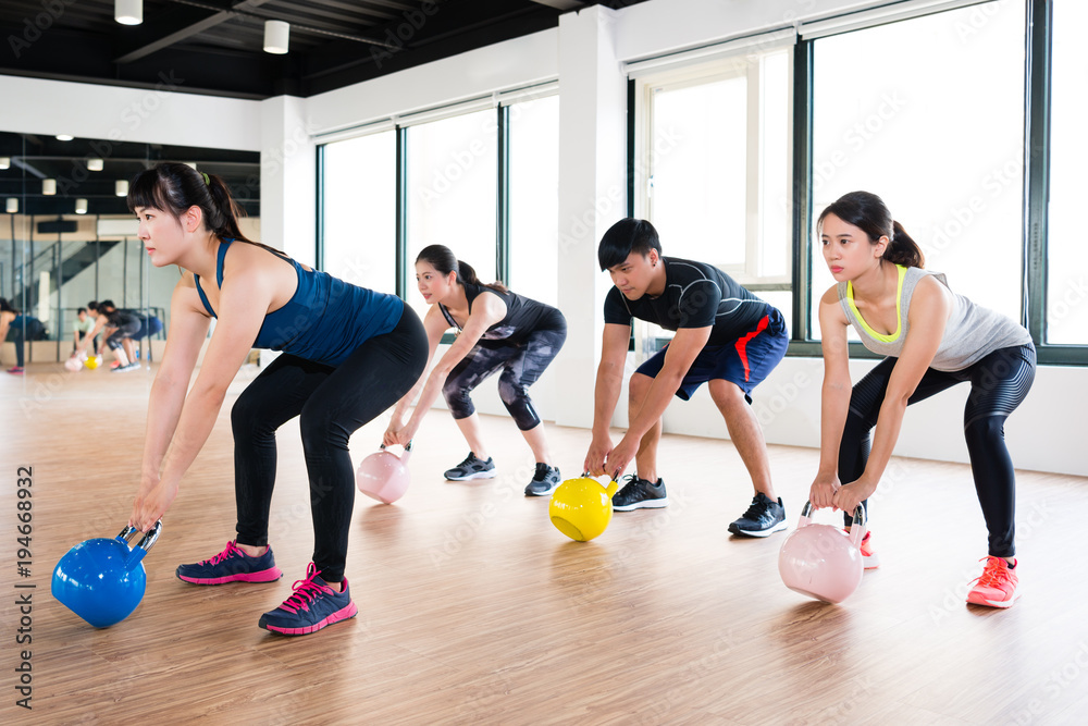 team of fitness player exercise with kettlebell team of fitness player exercise with kettlebell
