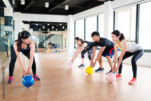 coach showing how to work kettlebell