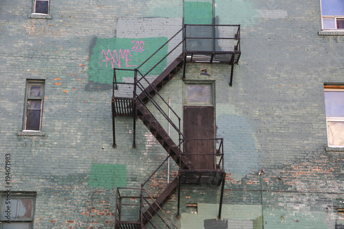 Fire stair at a green brick wall building photo