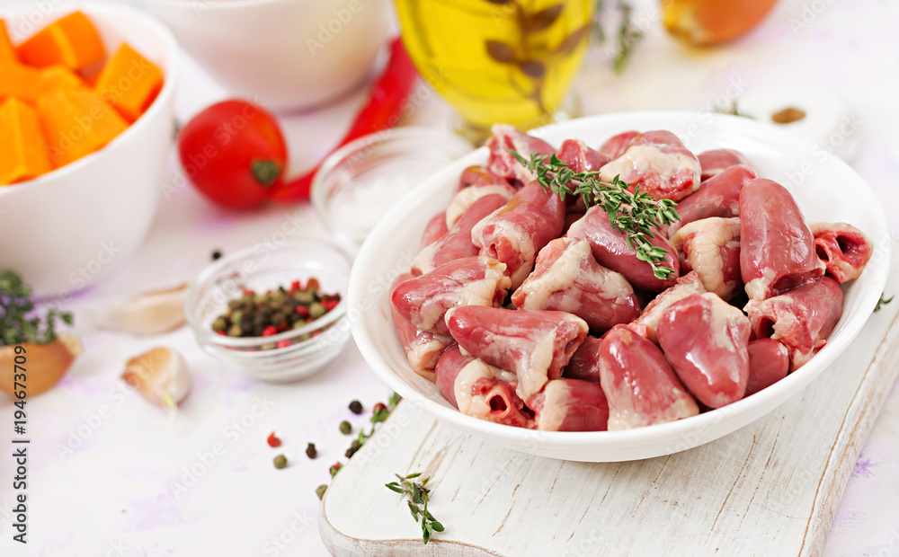 Ingredients for cooking chicken hearts with pumpkin and tomatoes in tomato sauce. The garnish is served with boiled rice.