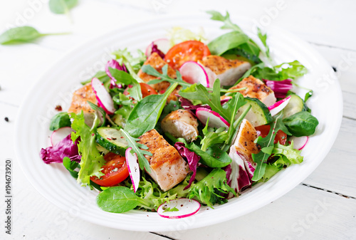 Fresh vegetable salad with grilled chicken breast - tomatoes, cucumbers, radish and mix lettuce leaves. Chicken salad. Healthy food.
