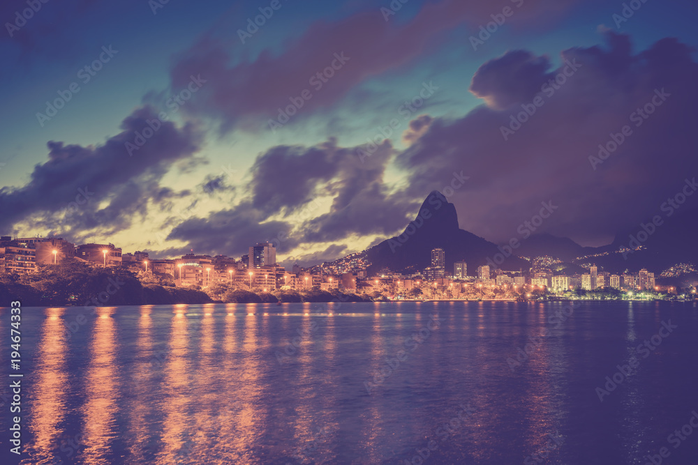 Mountains in Rio de Janeiro with water reflection at dusk, Brazil. Vintage purple colors Mountains in Rio de Janeiro with water reflection at dusk, Brazil. Vintage purple colors
