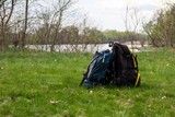 Two touristic backpacks on the riverbank. Hike concept