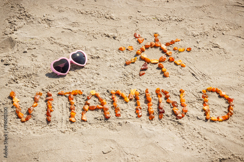 Sunglasses, inscription vitamin D and shape of sun at beach, summer time and healthy lifestyle concept
