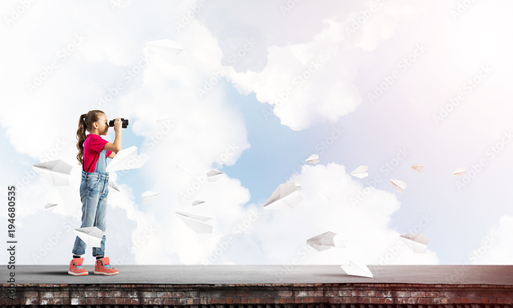 Concept of careless happy childhood with girl of school age looking in future Concept of careless happy childhood with girl of school age looking in future