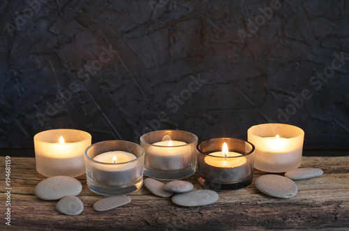 Burning candles on weathered wood