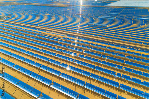 Aerial view of a solar farm producing clean renewable sun energy in California, industrial landscape