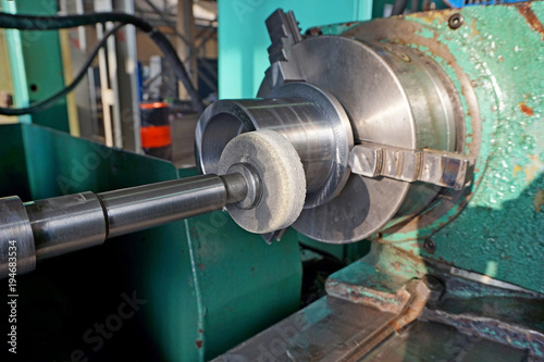 Spindle with an abrasive circle for intra grinding work on the grinder. Dry grinding by a circle end face by a long frame and thin white stone. There grinding inner sleeve hole.