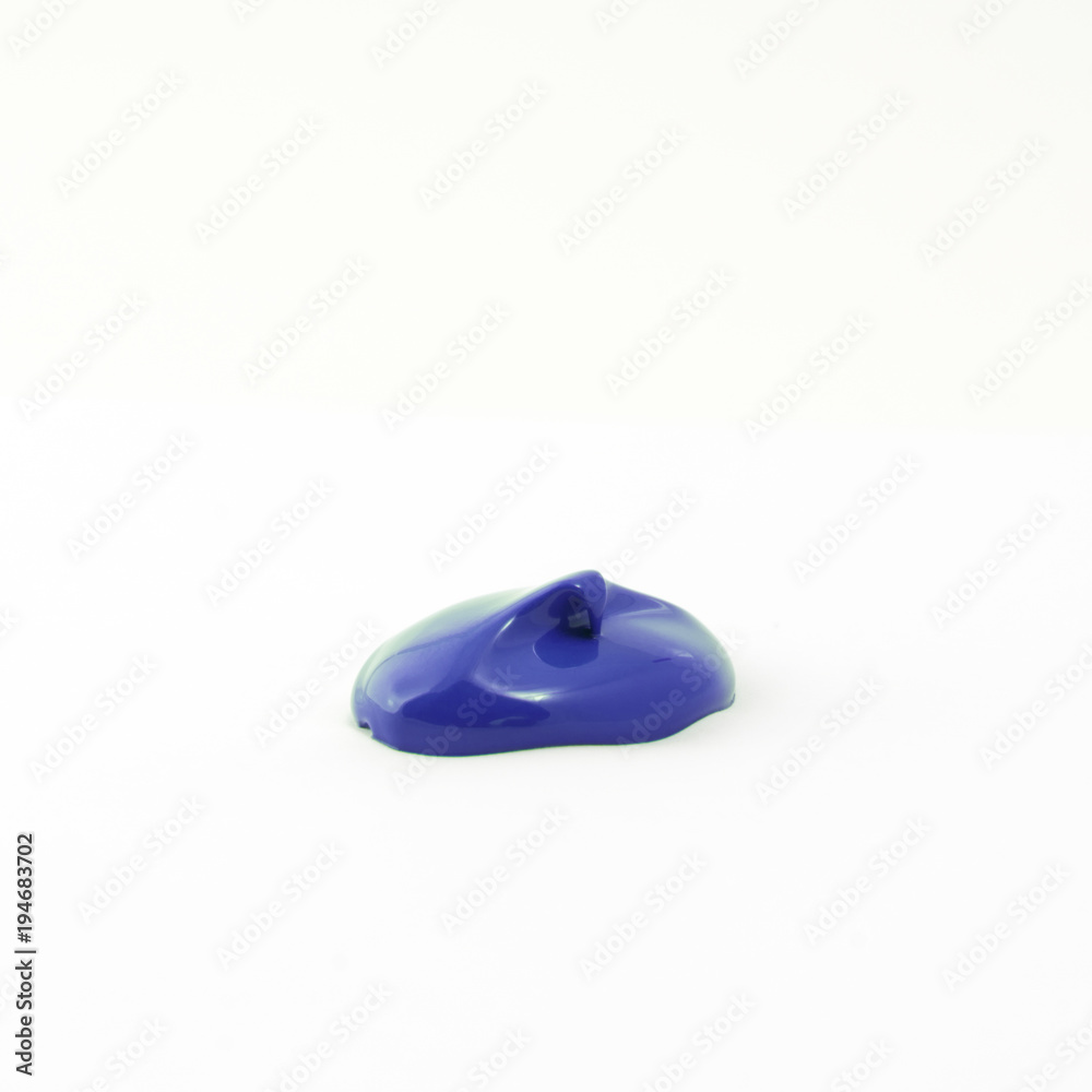a drop of acrylic blue color on a white surface a drop of acrylic blue color on a white surface
