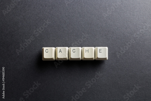 Word cache made using computer keyboard buttons on a black background. Compact disk. IT technology concept.