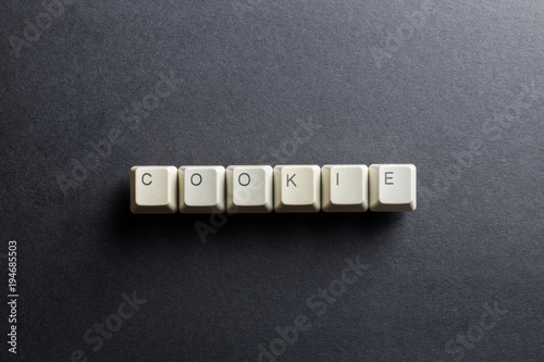 Word cookie made using computer keyboard buttons on a black background. IT technology concept.