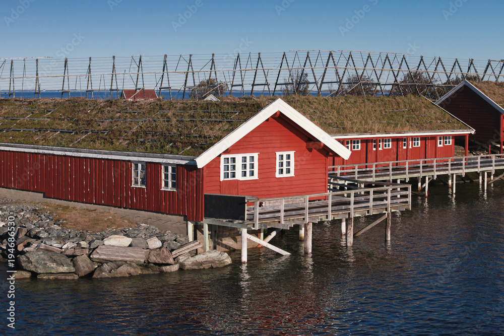 Fototapeta premium Red wooden houses on rocky island. Norway