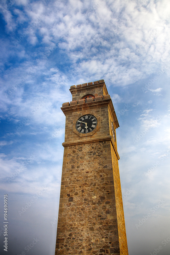 Galle Clock Tower (Anthonisz Memorial Clock Tower) against a blue sky in the Galle Fort, Southern Province, Sri Lanka