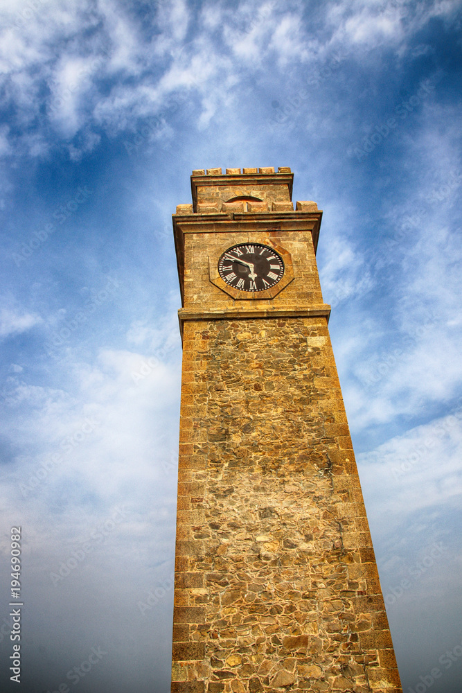 Galle Clock Tower (Anthonisz Memorial Clock Tower) against a blue sky in the Galle Fort, Southern Province, Sri Lanka
