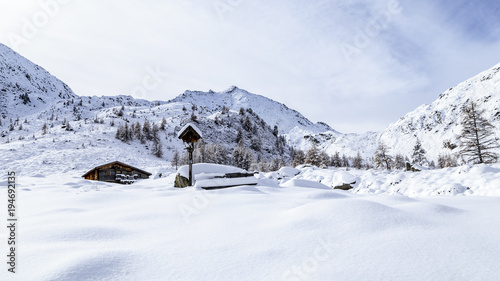 Alpine hut covered by the snow