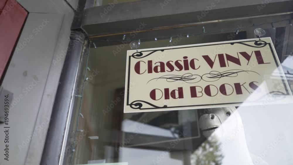 Antique store reflecting with “classic vinyl old books” sign. Antique store reflecting with “classic vinyl old books” sign.