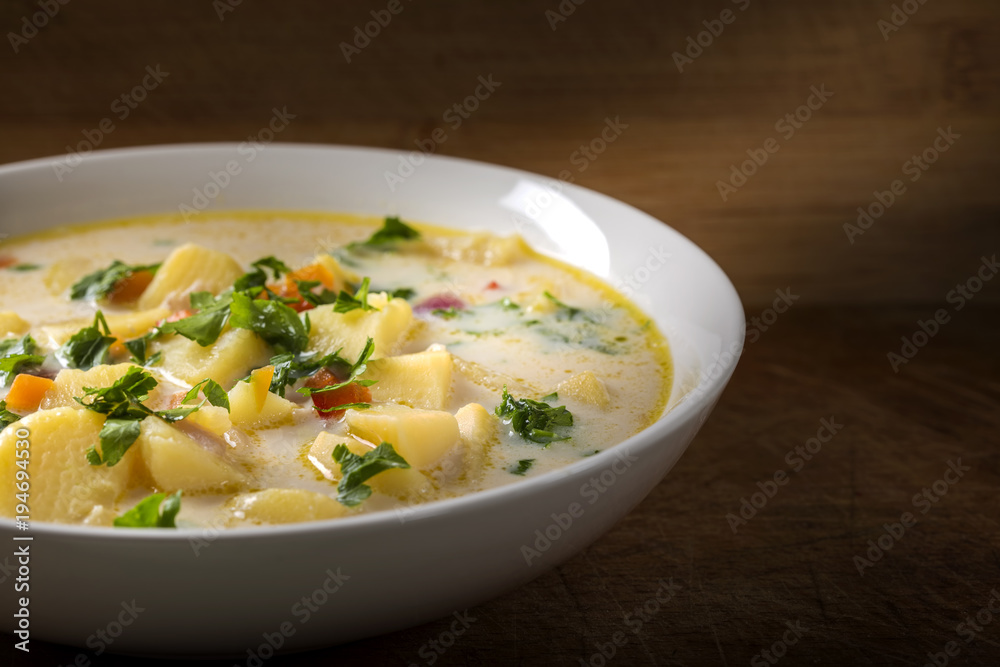 Homemade potato soup with sour cream and vegetables