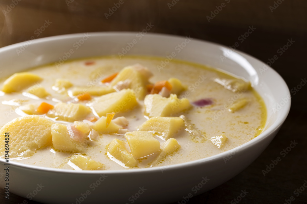 Homemade potato soup with sour cream and vegetables