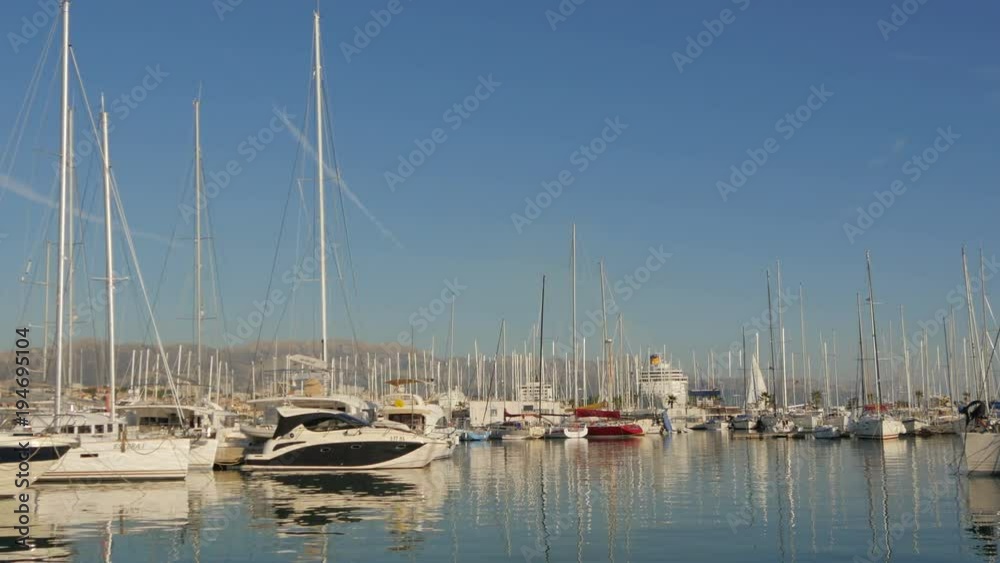 Pan left view of anchored sailing boats