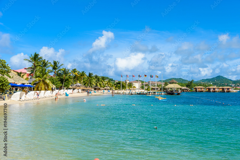 Pigeon Island Beach - tropical coast on the Caribbean island of St. Lucia. It is a paradise destination with a white sand beach and turquoiuse sea.