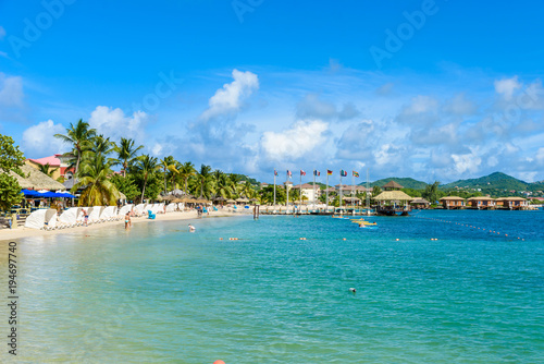 Pigeon Island Beach - tropical coast on the Caribbean island of St. Lucia. It is a paradise destination with a white sand beach and turquoiuse sea. photo