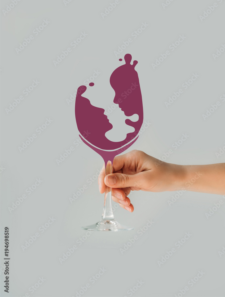 Cropped image of woman holding wine glass with couple silhouette isolated  on gray Stock Photo | Adobe Stock