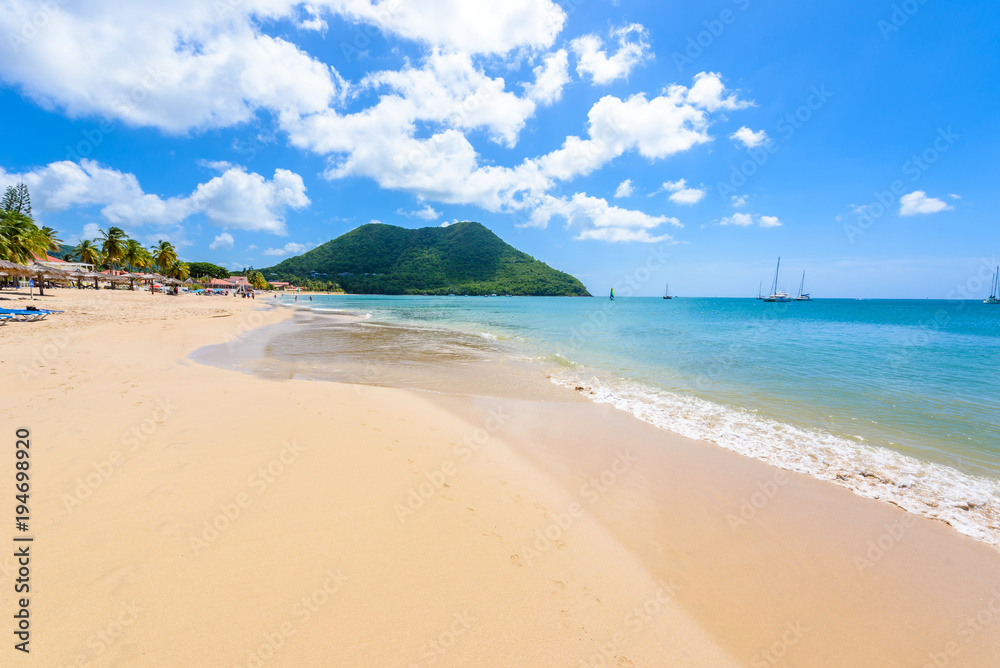 Fototapeta premium Reduit Beach - Tropical coast on the Caribbean island of St. Lucia. It is a paradise destination with a white sand beach and turquoiuse sea.