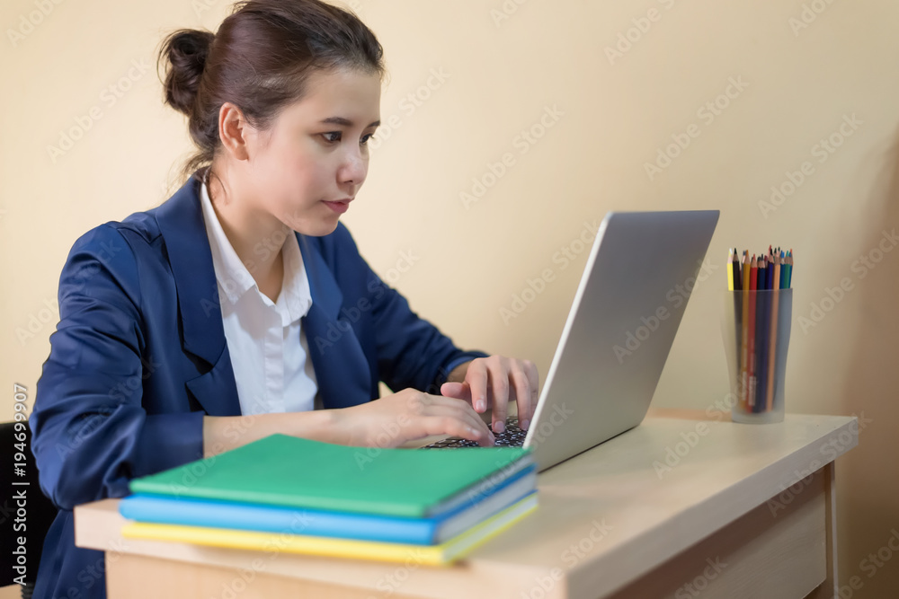 Experienced Asian journalist typing press release for online issue using laptop computer and wireless connection to internet in office copy space area for your advertising content or text. Experienced Asian journalist typing press release for online issue using laptop computer and wireless connection to internet in office copy space area for your advertising content or text.