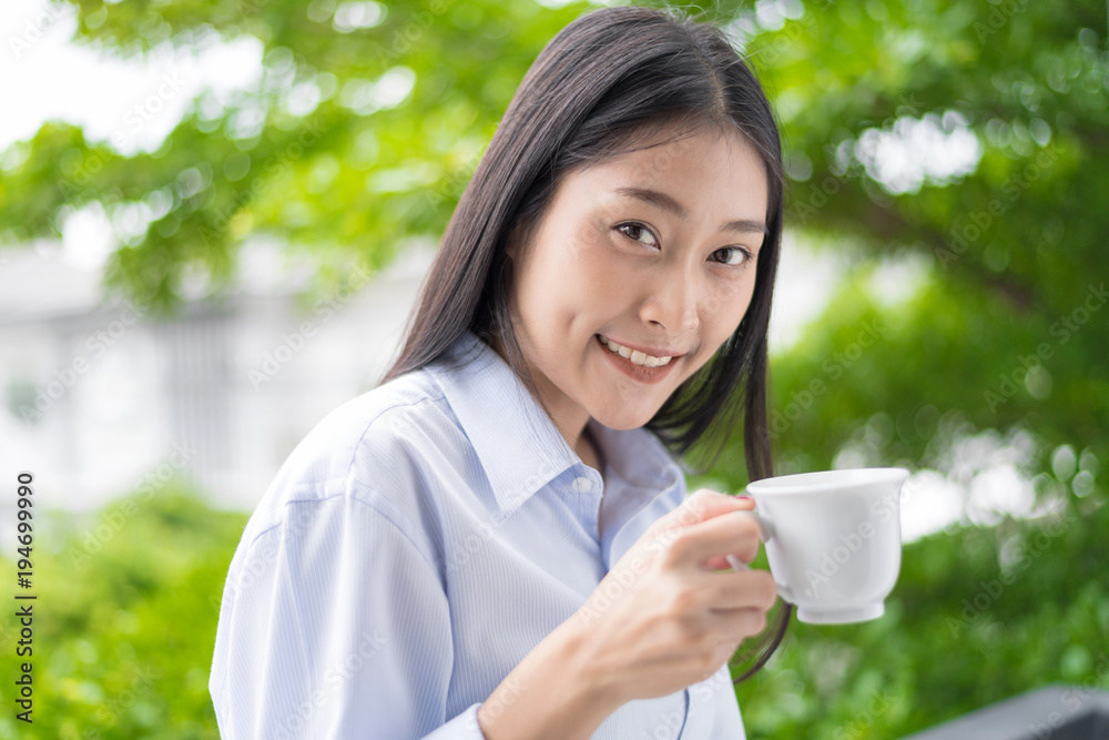 Morning coffee is my daily routine.Woman holding hot cup of coffee or tea in morning sunlight. Morning coffee is my daily routine.Woman holding hot cup of coffee or tea in morning sunlight.