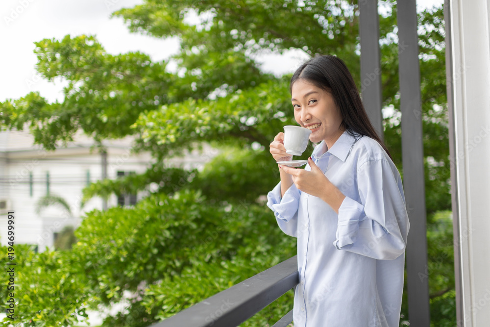 Morning coffee is my daily routine.Woman holding hot cup of coffee or tea in morning sunlight. Morning coffee is my daily routine.Woman holding hot cup of coffee or tea in morning sunlight.