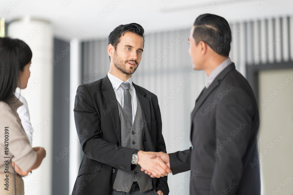 Confident business people are shaking hands after agreeing to a successful job. Business Team Partnership Greeting Handshake Concept. Confident business people are shaking hands after agreeing to a successful job. Business Team Partnership Greeting Handshake Concept.
