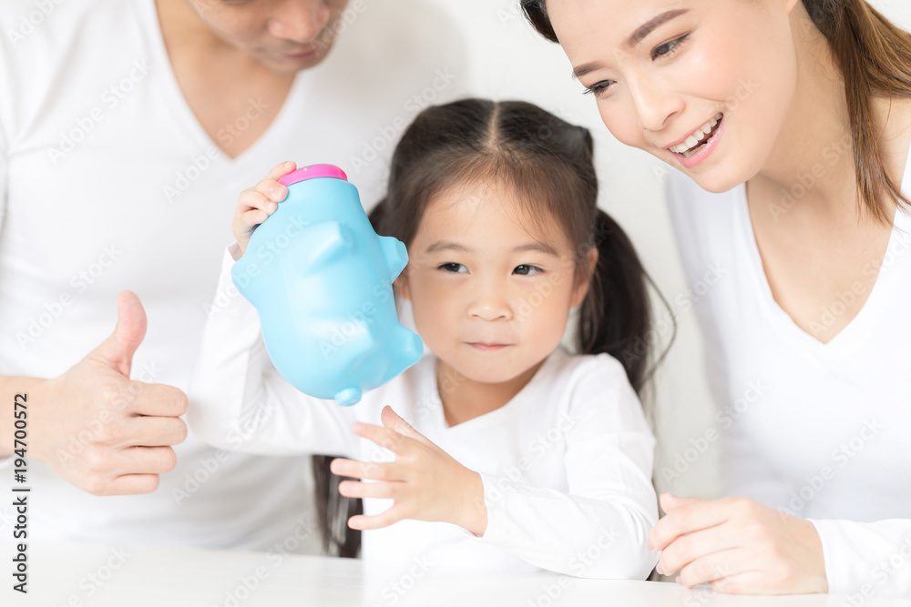 Parents are teaching daughter on saving money and financial planning. Parents are teaching daughter on saving money and financial planning.