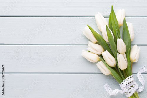 Mother s Day  woman s day  easter  white tulips  presents on gray  background.