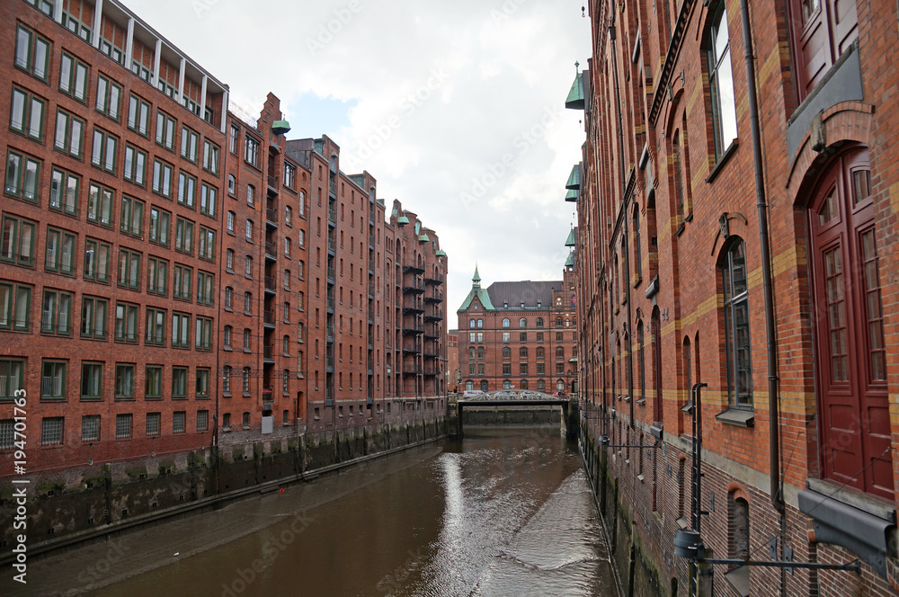 
Speicherstadt. Port warehouse in Hamburg. Hamburg is a harsh German city. The urban landscape of northern Germany. View of city canals from the bridge.