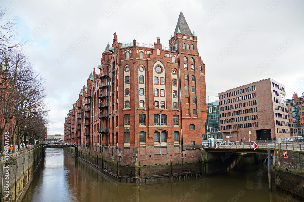 
Speicherstadt. Port warehouse in Hamburg. Hamburg is a harsh German city. The urban landscape of northern Germany. View of city canals from the bridge.
